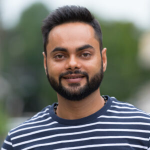 Portrait of a young bearded Indian man outdoors, representing satisfied customers of Melbourne Cheap's waste management services.